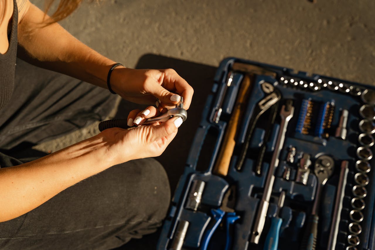 Why 91% of Watford Homeowners Trust Licensed Plumbers (And How to Spot a Scam) 2 Close-up of hands using tools from a toolset in a well-lit workshop setting.